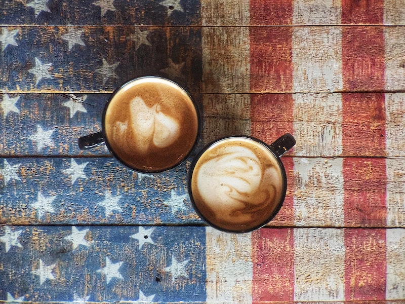 two cappuccinos on american flag wooden table