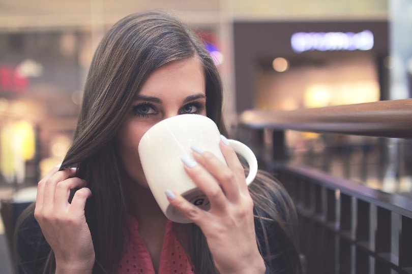 a woman drinking a coffee
