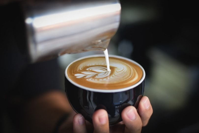 a woman making a cup of coffee