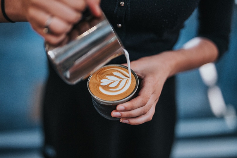 a woman preparing cafe latte