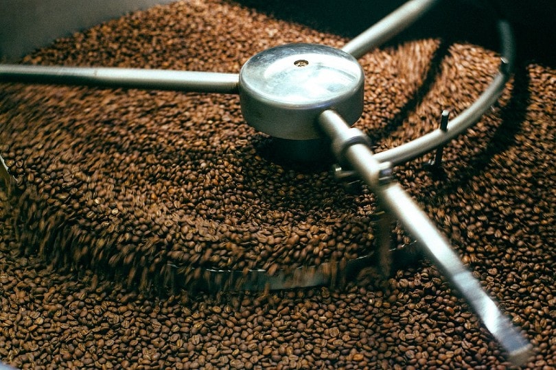 coffee beans roasting in a metal equipment