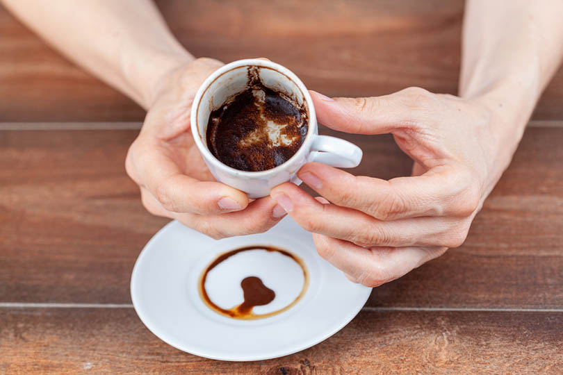 coffee fortune telling using leftover coffe grounds in ceramic Turkish coffe cup