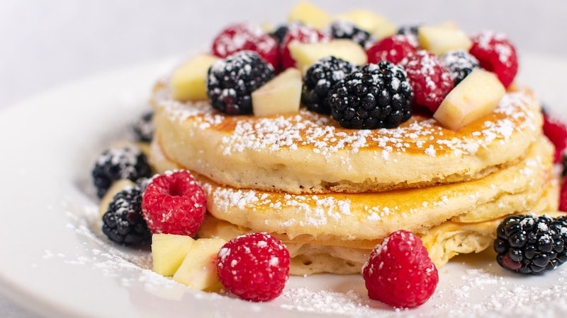coffee pancakes with berries and powdered sugar