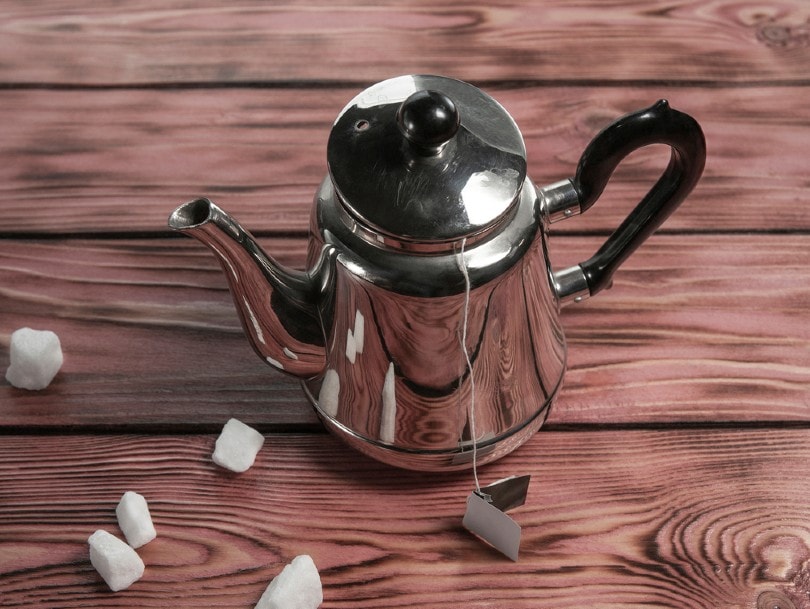 coffee pot and white sugar on wooden background