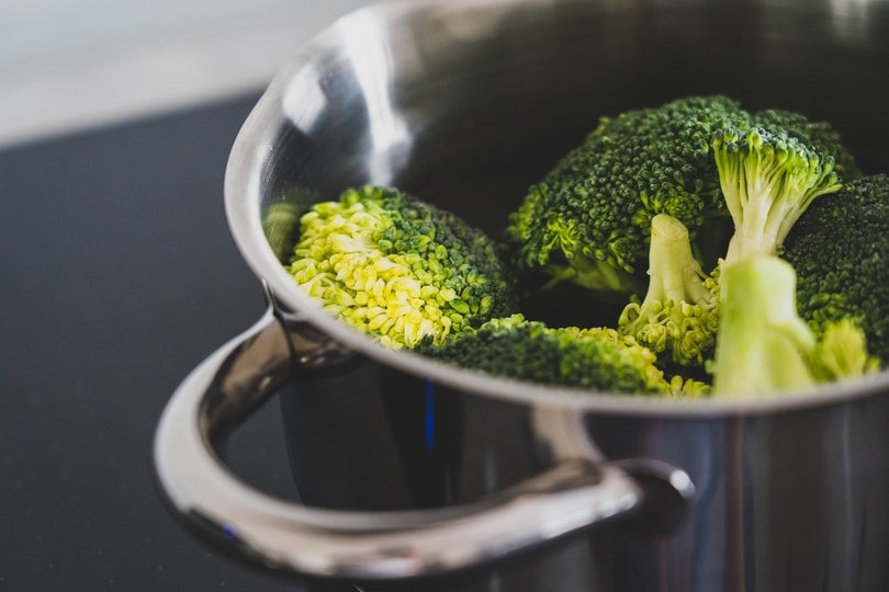 cooking broccoli in a stainless steel pot