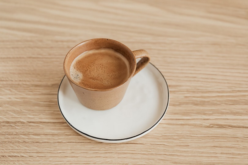 cup of coffee on wooden background