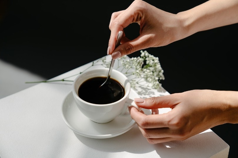hand of a woman stirring coffee