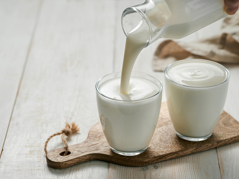 pouring buttermilk from a glass bottle