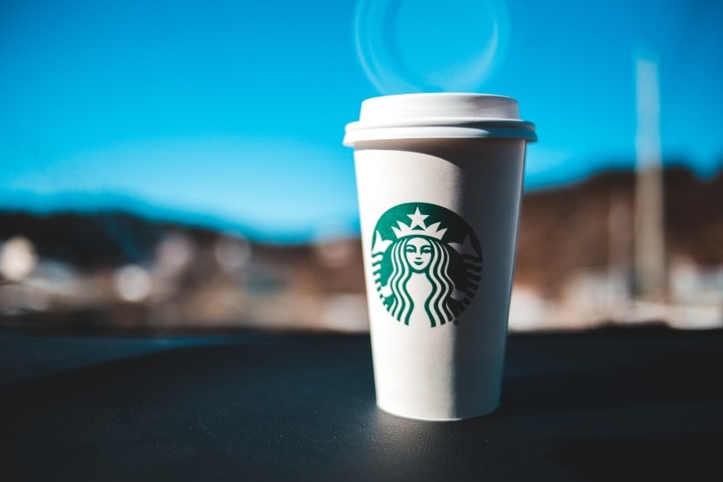 starbucks coffee cup on the dashboard