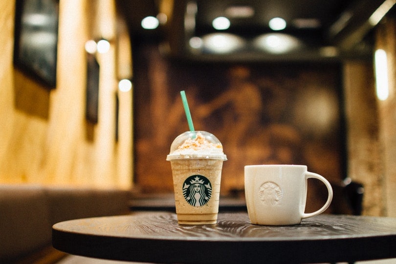 starbucks frappe and cup on table