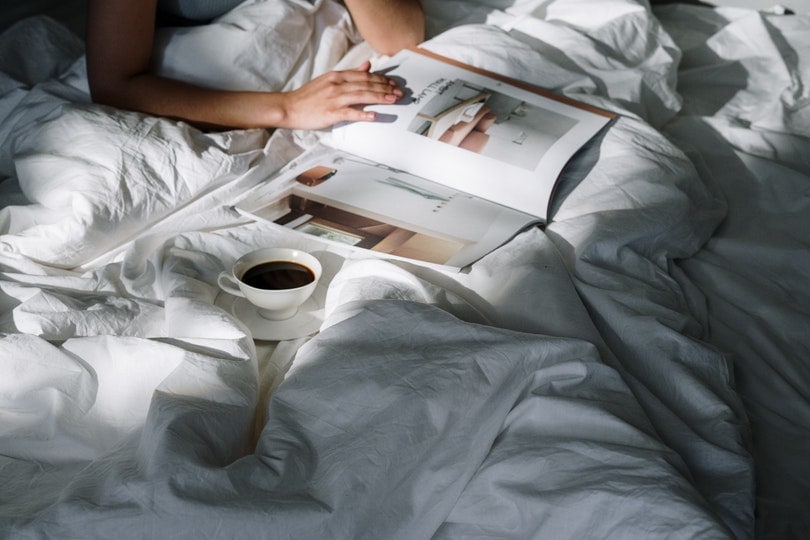 a cup of coffee on bed