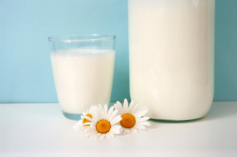 a glass and a bottle of creamer