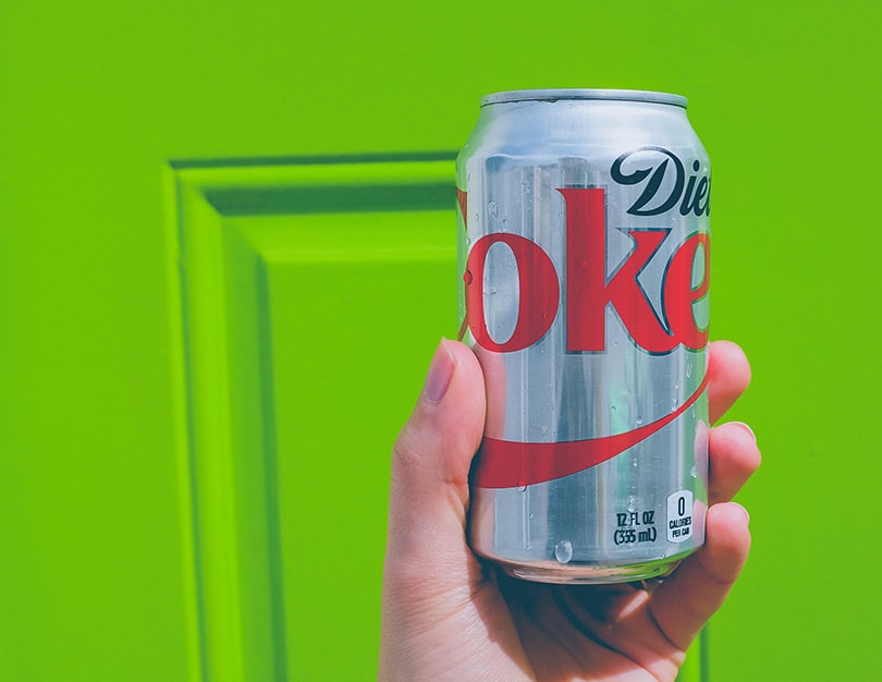 hand holding a can of diet coke