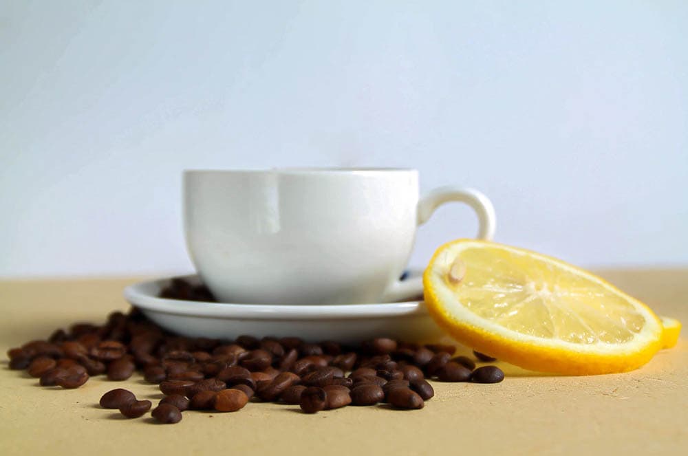 a cup of coffee with lemon