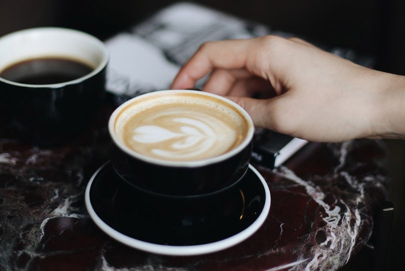 a person holding a cup of coffee