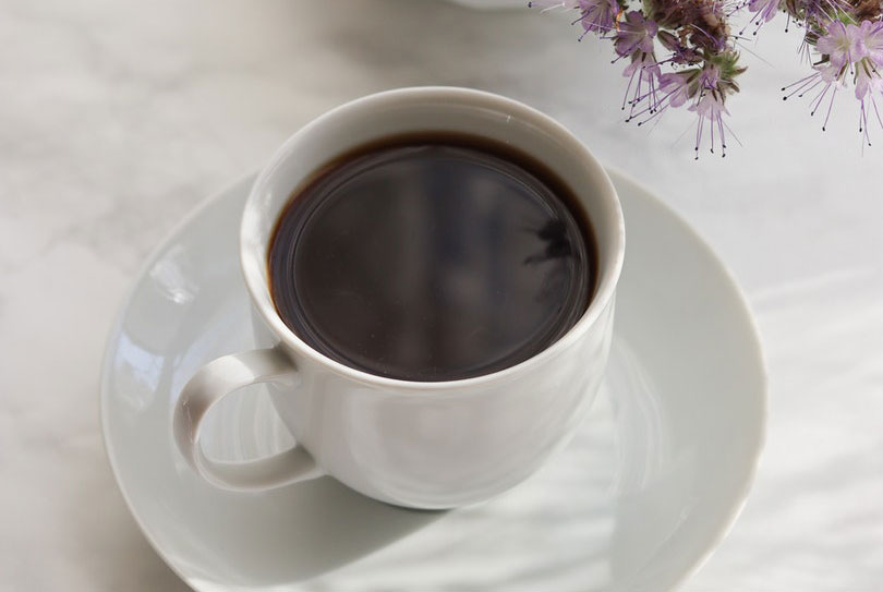 a white ceramic cup with coffee