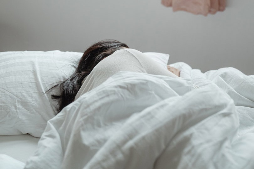 a woman sleeping on bed