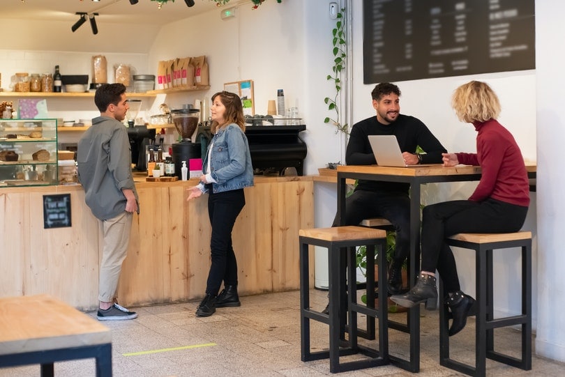 people having conversation in a coffee shop