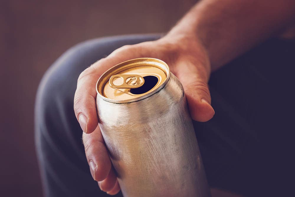 person holding a can of energy drink