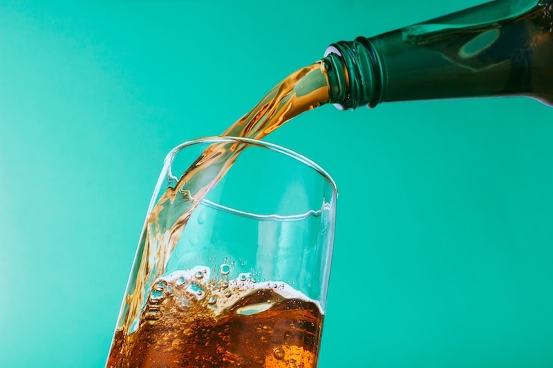 Barq's root beer soda pouring into glass