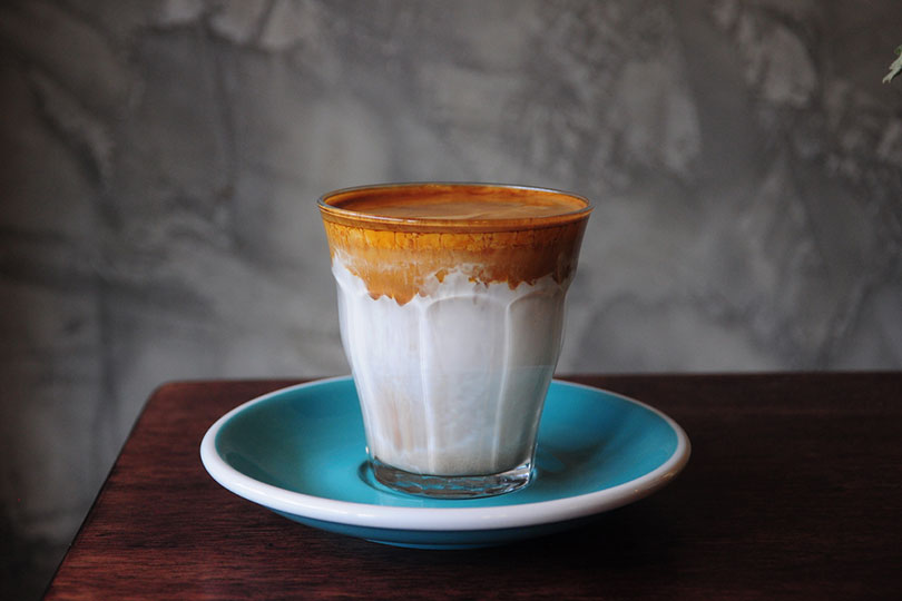 a cup of dirty coffee on a saucer