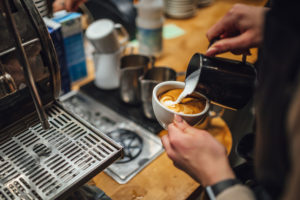 barista making coffee in coffee shop