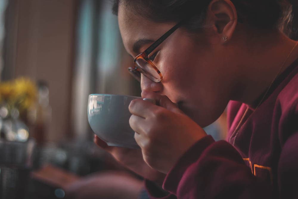 close up young woman drinking a cup of coffee