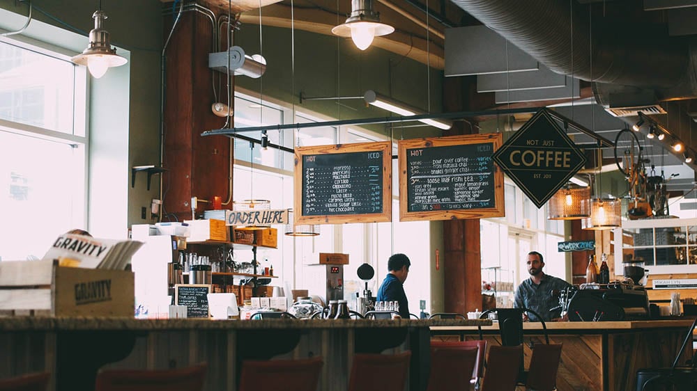 interior of a coffee shop with two men at the counter