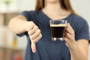 woman thumbs down on coffee