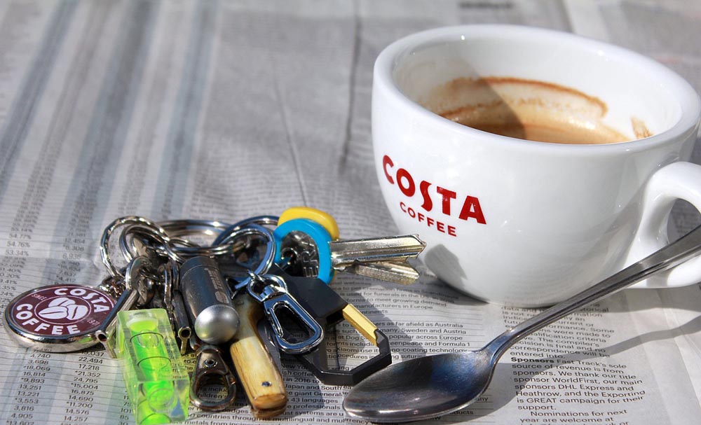 a cup of hot costa drink with keys