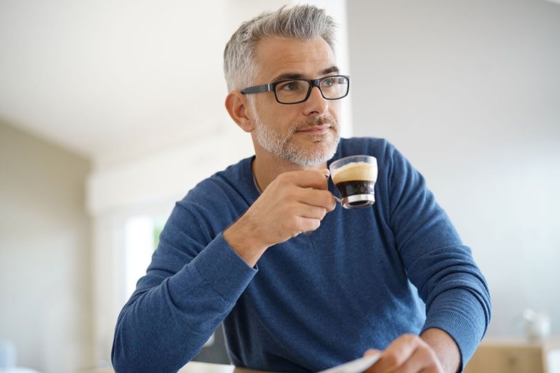 middle-aged man drinking coffee at home