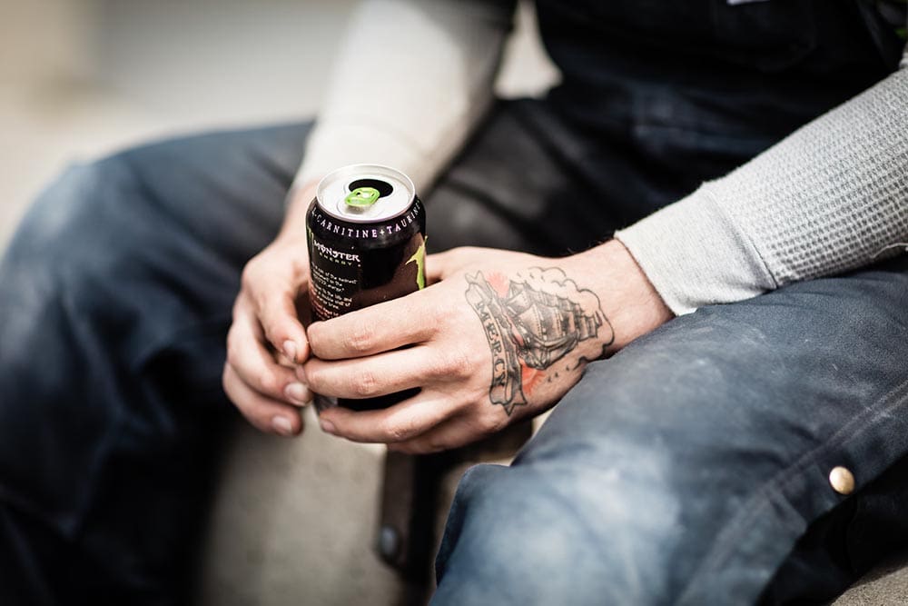 person holding a can of energy drink