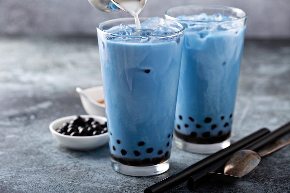 two glasses of Butterfly pea milk with pearls