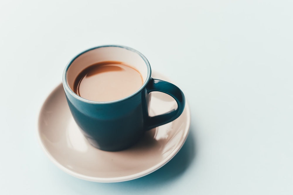 a cup of coffee on a blue mug