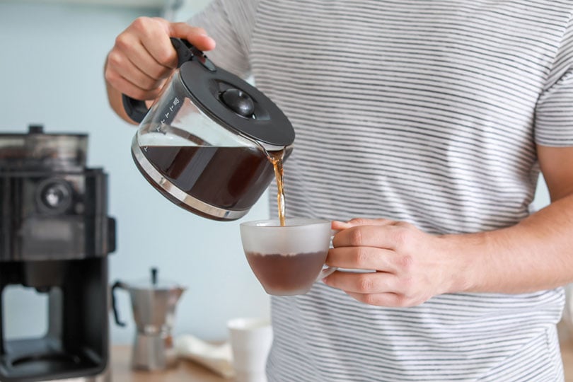 man pouring coffee