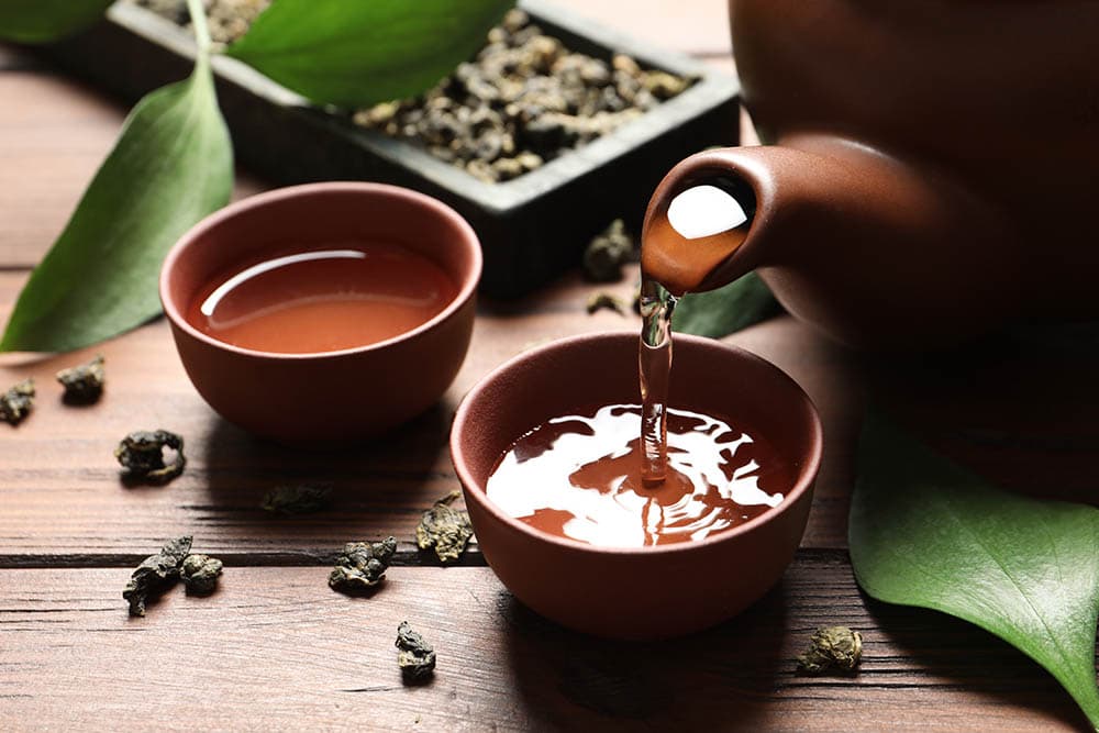 Oolong-Tee in eine Tasse gießen
