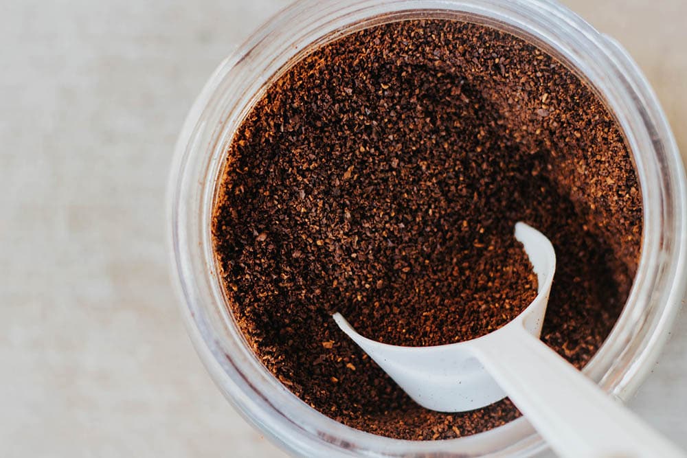 scooper in a jar of ground coffee