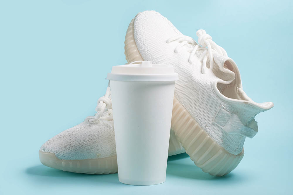 white sneakers and a cup of coffee