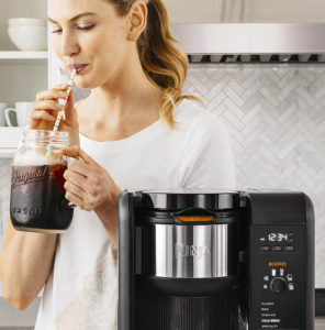 woman drinking coffee from SharkNinja Hot and Cold Brewed System, Auto-iQ Tea and Coffee Maker
