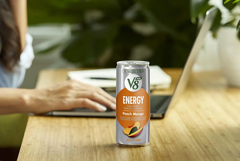 V8 +ENERGY Peach Mango Energy Drink on a table