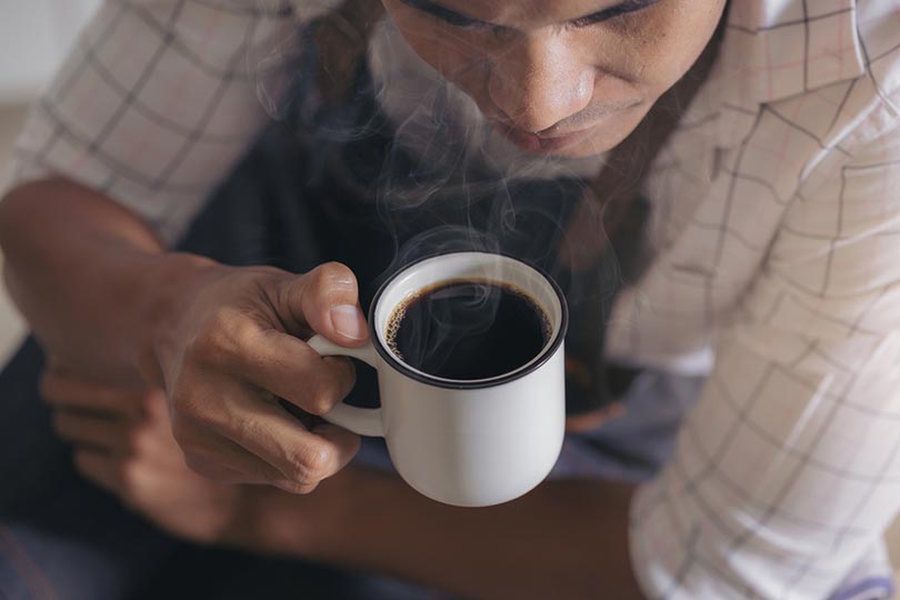 asian man drinking coffee