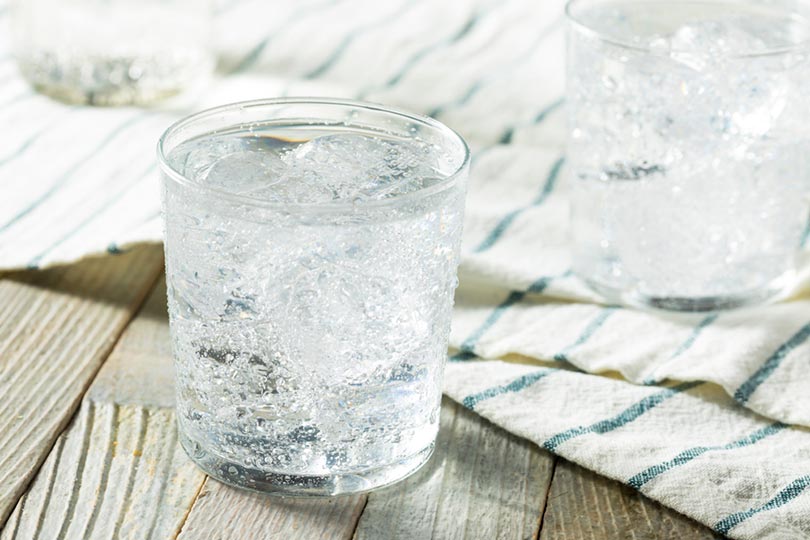 fresh sparkling water with ice in a glass