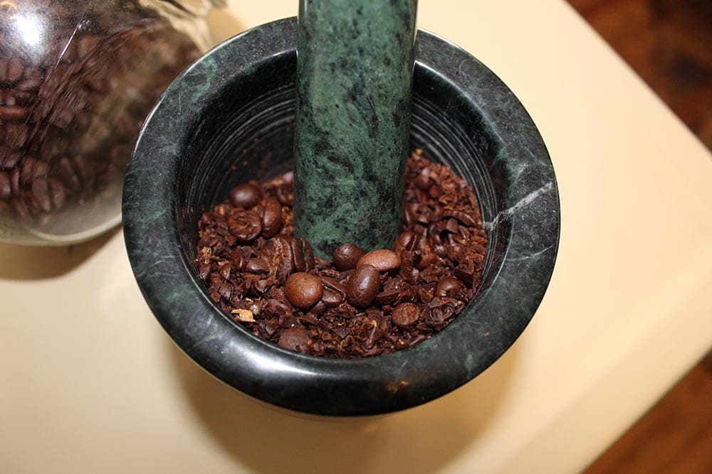 grinding coffee using mortar and pestle