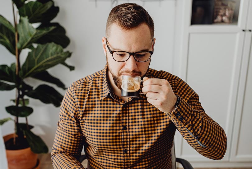 man drinking coffee at home