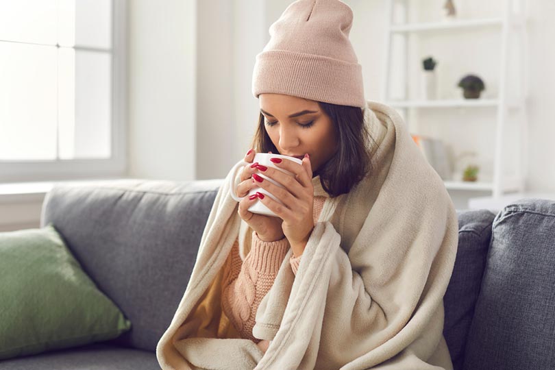 sick woman drinking coffee