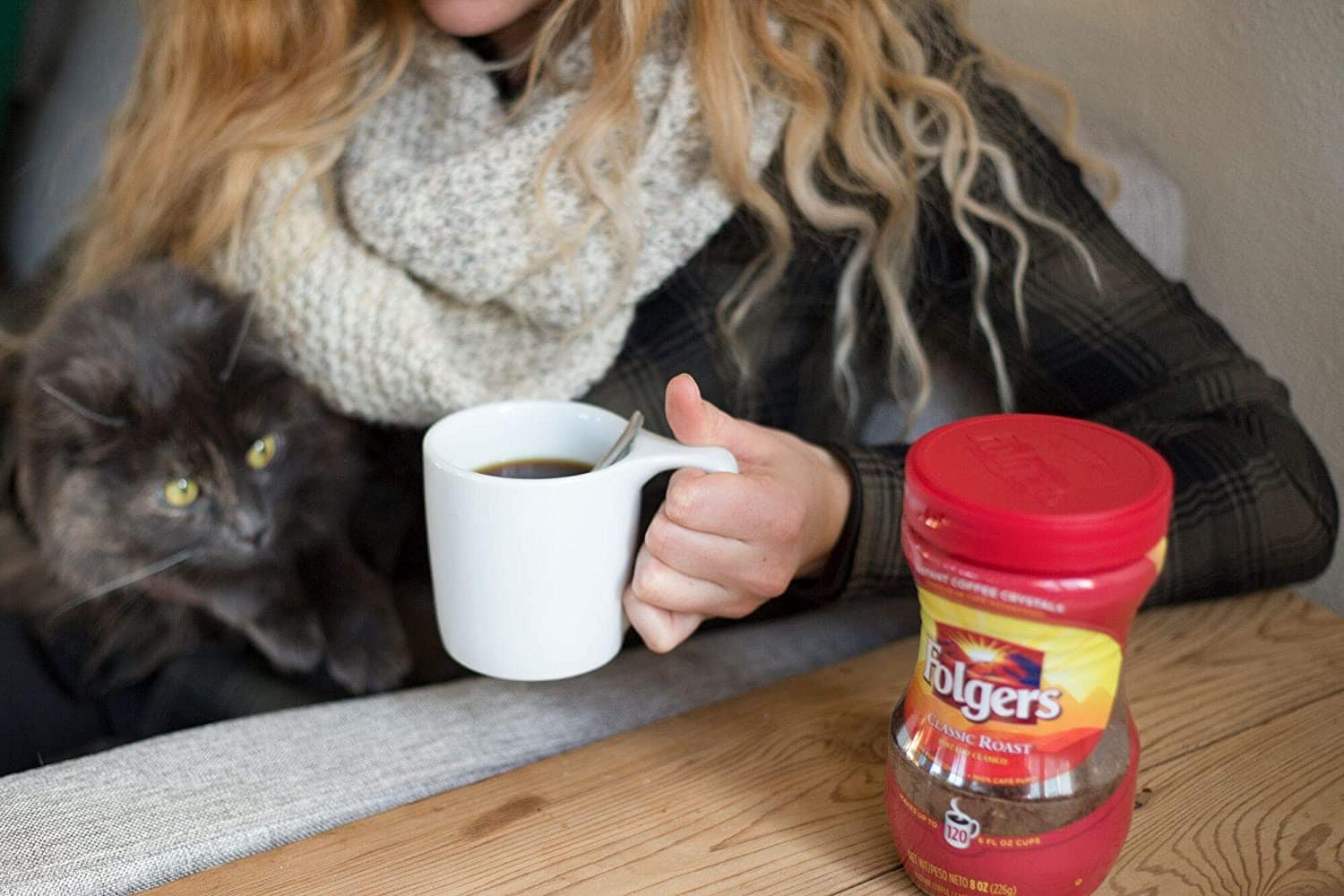 woman having a cup of Folgers Classic Roast Instant Coffee Crystals