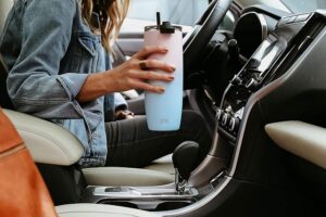 woman holding Simple Modern Travel Coffee Mug Tumbler inside the car