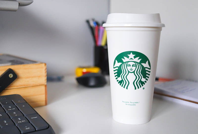a cup of starbucks coffee on a desk
