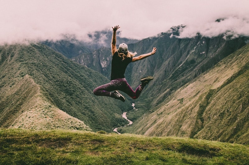 energetic woman jumping in nature