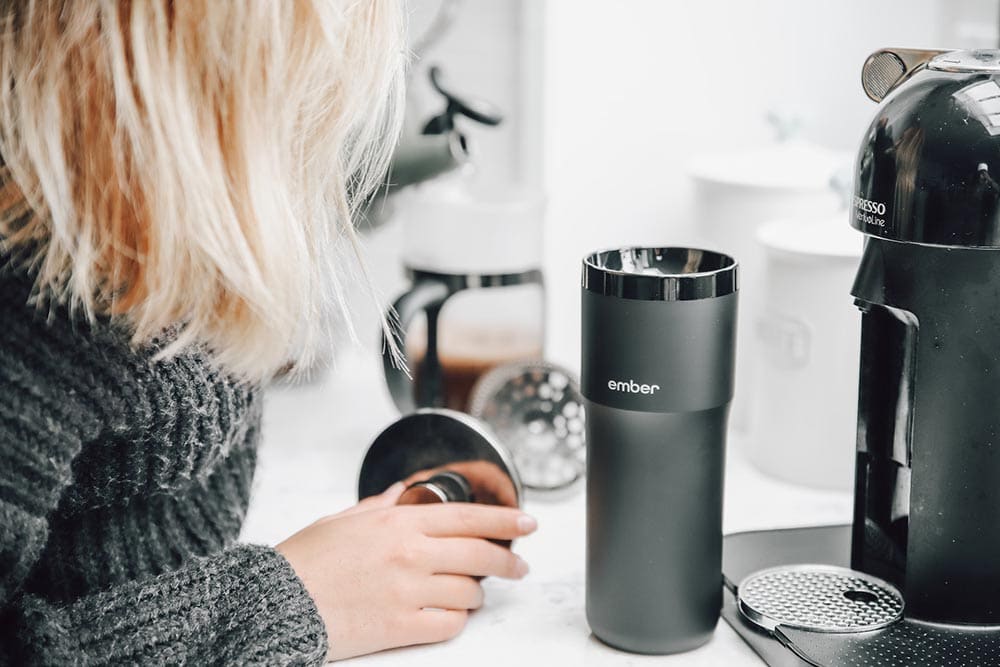 putting coffee to a stainless tumbler